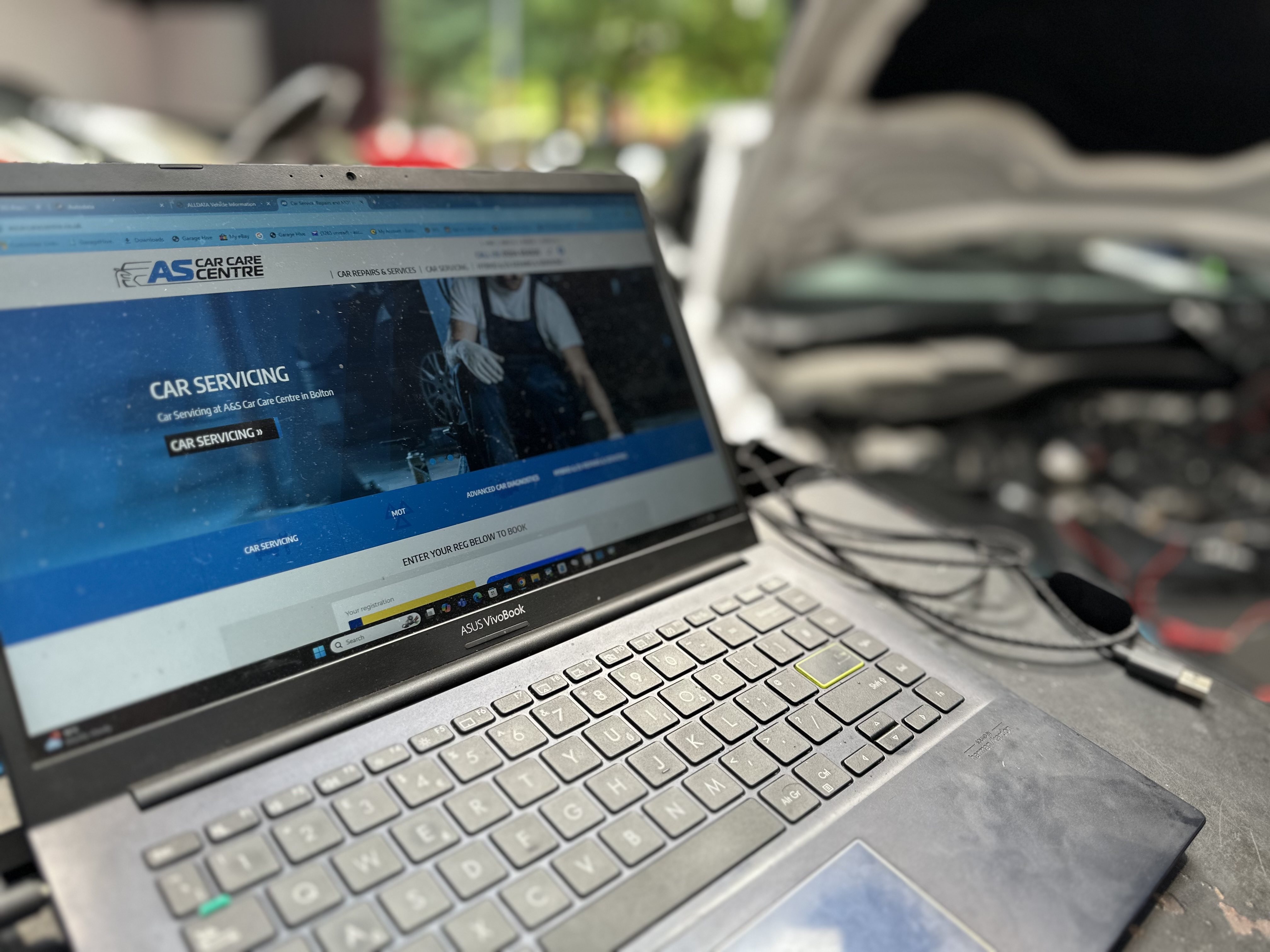 A&SCarCareWebsite - Profitable Work - Image shows open laptop in garage with A&S Car Care website showing